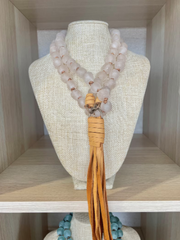 Blush African glass beads with antique brass findings and deerhide tassel