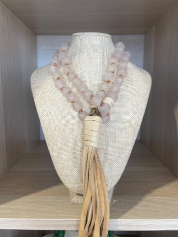 Blush African glass beads with antique brass findings and deerhide tassel