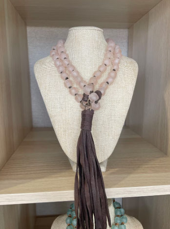 Blush African glass beads with antique brass findings and deerhide tassel